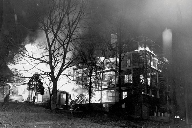 A black and white photo of the Central Building at Asheville’s Highland Hospital on fire | Blue Ridge Country