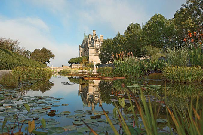 Exterior-Shot-of-the-Pond-at-Biltmore-Estate-with-Flowers-and-Building-in-Background.jpg