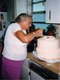 Janann Giles’ mother decorates a wedding cake.