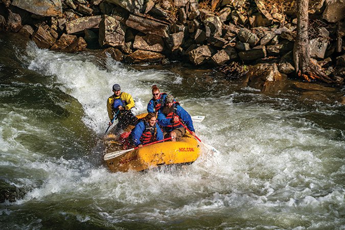 Whitewater-Rafting-at-Nantahala-Outdoor-Center-With-Rocks-In-Background.jpg