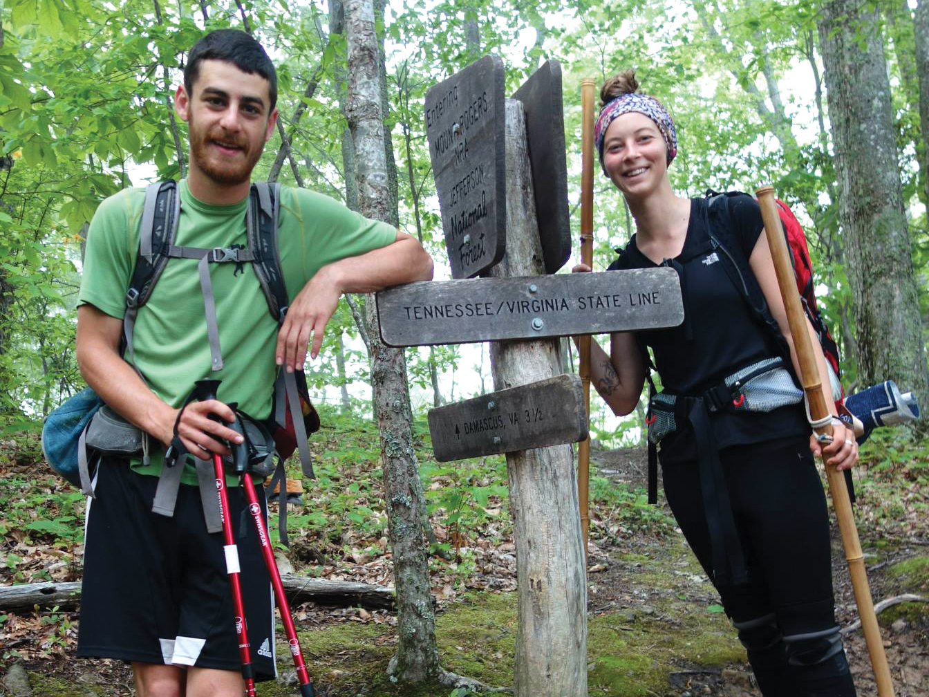 Noah Naseri and Kayla Carter pause at the Virginia/Tennessee line during their Appalachian Trail hike.