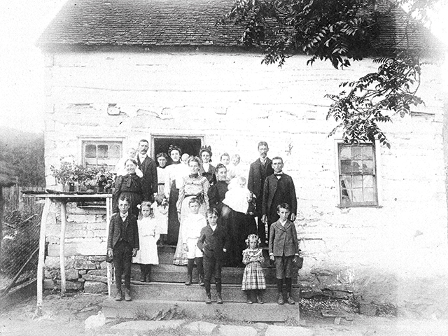 A group of unidentified Zittles clusters around the family home in this undated photo.