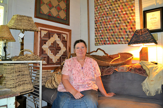 Nancy Basket, here in her home gallery in Walhalla, South Carolina, tells the ancient stories through her work as a basket maker and fiber artist.