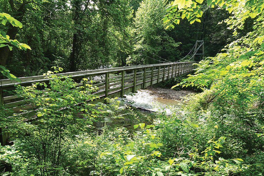 The swinging bridge crosses the Jackson River.