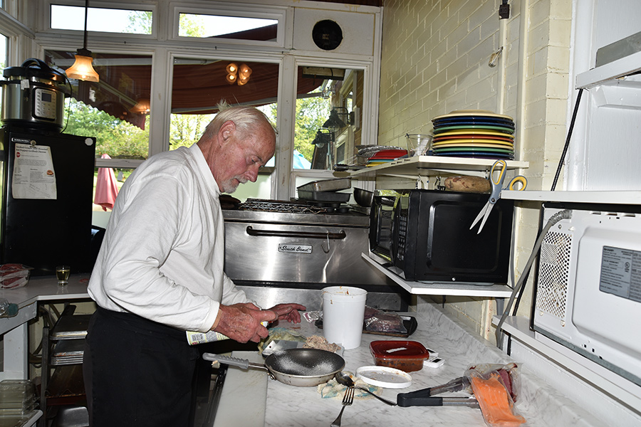 Dave Zorn, co-owner of Locust Hill, preparing dinners for Trivia Night guests.
