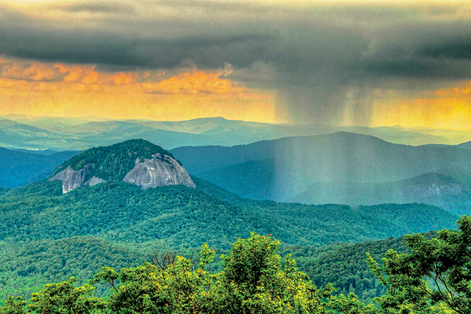 Looking Glass Rock is visible from several points along the North Carolina Blue Ridge Parkway (Looking Glass Rock Overlook is at Milepost 417). From the photographer: “As I approached Looking Glass Rock, the stormy cloud was way to the left of the rock face. I gathered my photo gear from the car and began setting up my tripod and camera.  After about 10 minutes, the storm cloud reached just the right spot and I took my shot.”