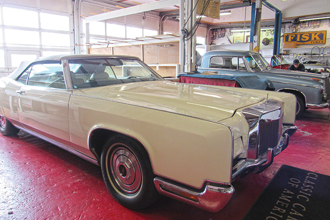 A 1972 custom-built Lincoln waits in bay with a 1959 Mercedes Benz 220S for mechanical rehab.