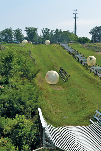 zorbing in pigeon forge
Climb inside a giant inflatable globe that’s tucked inside a larger ball and roll down a hillside. It’s called Zorb and it’s one of the newest adventure sports out of New Zealand. Pigeon Forge, Tenn., boasts the first Zorb site in North America.
There are some choices here – you can be strapped in a safety harness inside a dry ball known as a Zorbit or you can spin and slosh your way down the mountainside in a Zydro ball that’s partially filled with water. Strapped participants careen down the slope solo while the water balls can carry up to three people at a time. If you stand at the top of the run and lose your nerve, they’ll give you a refund. The daredevils who do accept the challenge can relive the experience on video. A camera is tucked inside the ball to record all the fun.
The Pigeon Forge site offers a straight track and a more challenging zigzag course. The Zorbit travels only the straight path. Check it out at zorb.com.
~Marla Hardee Milling