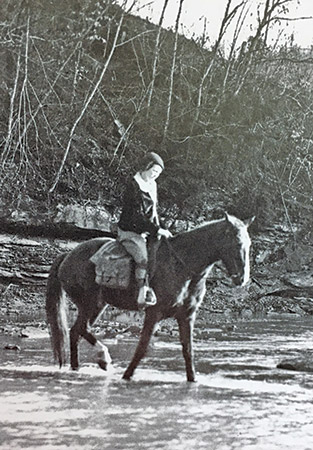 A pack horse librarian fords Cut Shin Creek.