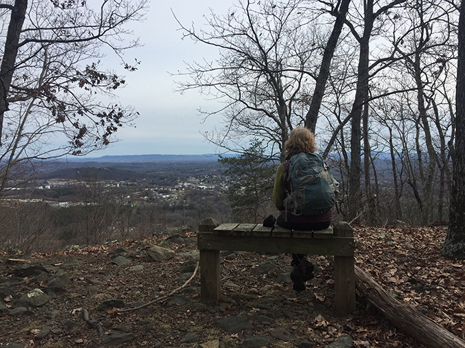 The Day Hiker overlooks Rocky Mount on a gray day along Grassy Hill's ridge line.