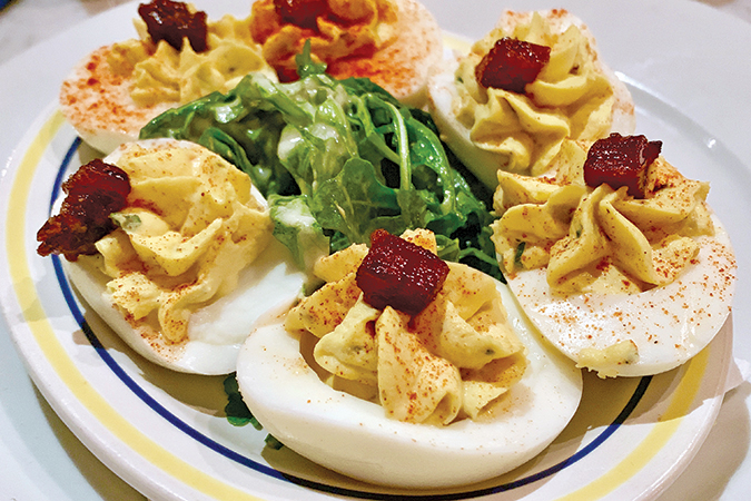 Deviled eggs are topped with candied bacon at The Public House.
