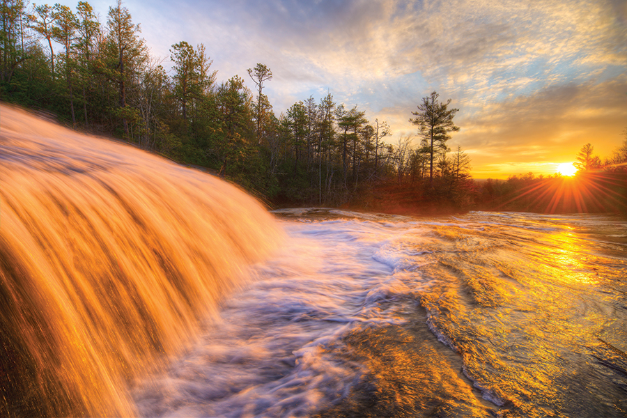 Light on the Water. The rising sun illuminates Bridal Veil Falls in DuPont State Recreational Forest, North Carolina.