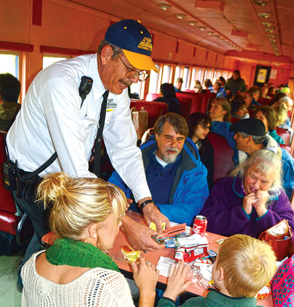 Licensed conductor Greg Kesner greets passengers aboard the Potomac Eagle Scenic Railroad.