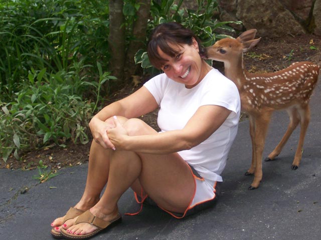Mimi the deer nuzzles the neck of Cheryl Moretz. Cheryl says those deer kisses pulled her out of deep depression during her husband’s illness.