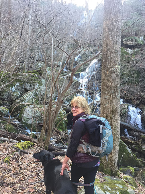 A girl and her dog at Apple Orchard Falls.