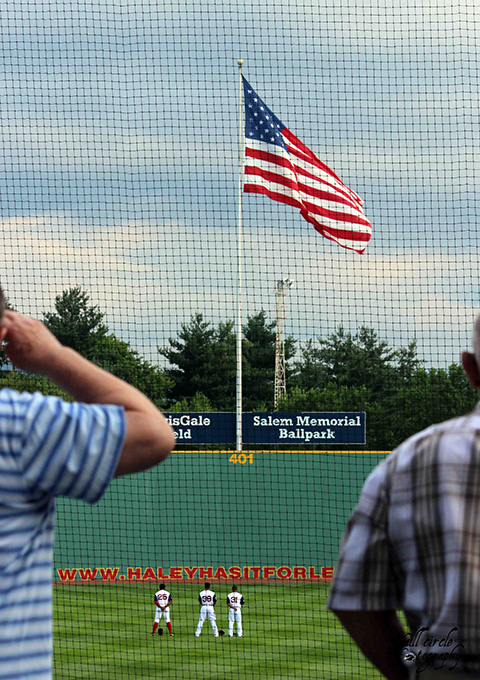 Saluting the flag prior to play.