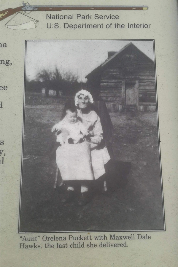 Aunt Orelena Puckett poses with Maxwell Dale Hawks, the last child she delivered, in a National Park Service photograph.
