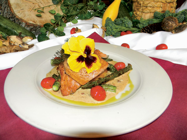 The farm-raised Sunburst Trout is served at Season's with grits cakes and tasso ham gravy.