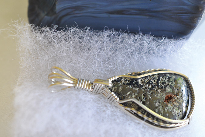 A piece made of Nelsonite, the State Stone of Virginia, rests next to uncut slag glass.