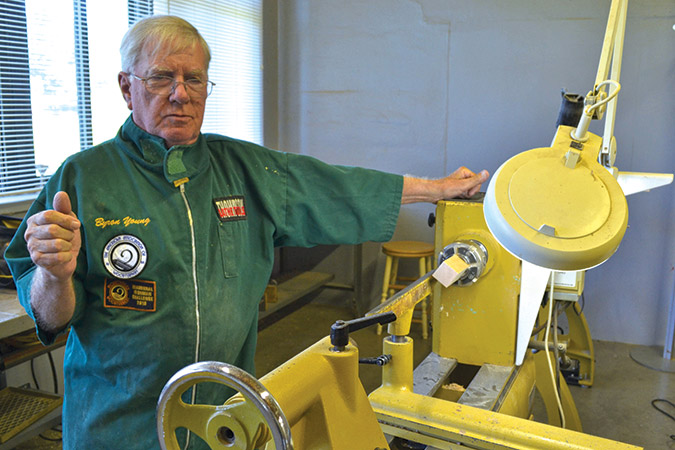 Byron Young, president of the West Virginia Mountaineer Woodturners, explains the different types of wood lathes at their workshop.