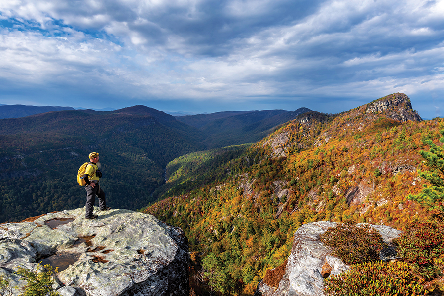 A hiker visiting the Chimneys (just past Table Rock on the Mountains-to-Sea Trail), gazing out toward Table Rock Mountain and the northern part of the Linville Gorge, North Carolina. From the photographer: “The Linville Gorge erupts with color each year around the middle of October, with higher elevations showing the first signs of autumn because of cooler temperatures. Hues of red, orange and yellow creep down the mountain and into the valley, making a spectacular show for gorge visitors.  The best viewing points include Wiseman’s View, the Chimneys or the main peaks of Hawksbill, Shortoff and Table Rock Mountains.”
