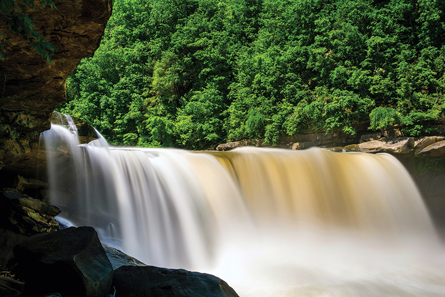 Cumberland Falls is a waterfall on the Cumberland River in southeastern Kentucky. Spanning the river at the border of McCreary and Whitley counties, the waterfall is the central feature of Cumberland Falls State Resort Park.