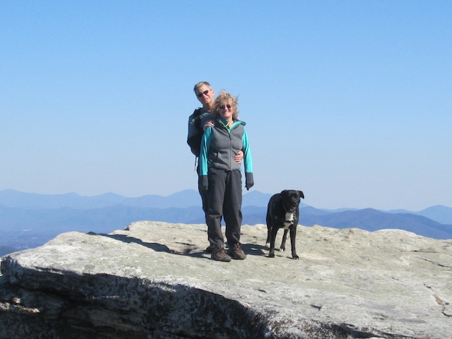 Kurt, Gail and Cookie on McAfee Knob, with the Peaks of Otter behind them on the horizon, 2/24/13; 9 years and one week into the hiking oddity.