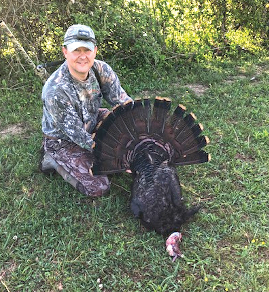 Lee Bryant poses with a turkey harvested on his property.