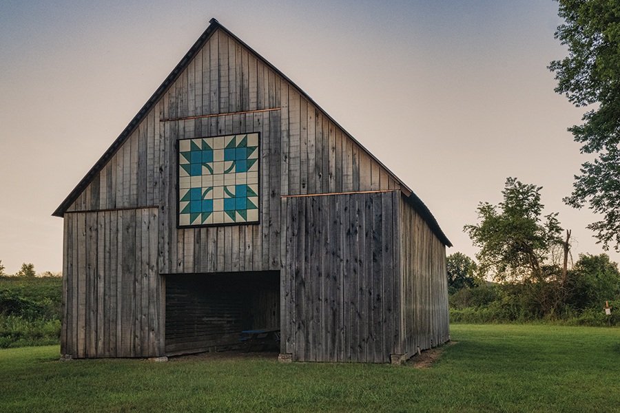 The Maple Leaf Barn is located at the Seven Islands State Birding Park in Kodak, Tennessee, east of Knoxville along the French Broad River. The park was created for birdwatching and it has a beautiful wildlife refuge and several hiking trails with views of the Great Smoky Mountains. Other activities at the park include kayaking, canoeing, biking and fishing. 
    From the photographer: “The barn was originally built and owned by the Creswell Family who lived on the property. They operated a small farm and sand-dredging operation on the river. The quilt pattern would have been added later when the park was established.”