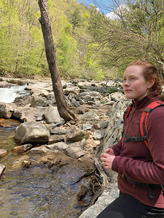 Lauren Stepp stands near the French Broad, where she grew up.