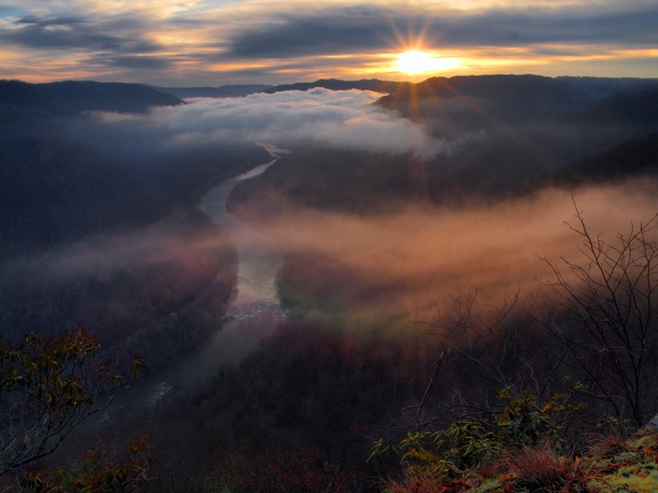 I've taken so many photographs over the last 2 months that I'm finally getting caught up on checking out some of my shots from on our Static Brothers trip to West Virginia a couple weeks ago. Our last day there we got up at 4 am for some Goetta and Eggs for breakfast and made the 45 minute drive to Grandview in the New River Gorge. When we arrived the gorge was full of fog and a hint of deep red had emerged far off in the distance, but not only did the color quickly fade, so did the fog closest to where we were shooting. My good friend Bryan Janosick and I had perched ourselves at the North Overlook, since there was much more room there if other photographers had already set up, but to our joy we were the only ones who had arrived. Hoping for a post sunrise show, we got some really cool light peeking through the clouds illuminating the fog in the valley. I've been experimenting with sunbursts of late and although this wasn't exactly what I wanted I still liked it. Talking outside of photography there really is nothing like standing cliff side here and watching the changing conditions as a sunrise approaches and happens. It's truly one of the gems of the Mountain State and one of my favorite places to start my day with good friends.

Christmas is just around the corner! Prints are available for most images! Feel free to look around on my Facebook page or visit my website www.fultzfotos.com for a great holiday gift idea for that loved one in your life! If interested don't hesitate to contact me at my email address, slakejustice@yahoo.com or Facemail me through my photography page.

© 2015 William H Fultz II. All Rights Reserved. Thank you for stopping by and having a look! Sharing is both appreciated and encouraged. Please do not download or use this image for personal use in any way with out the permission of William H Fultz II.