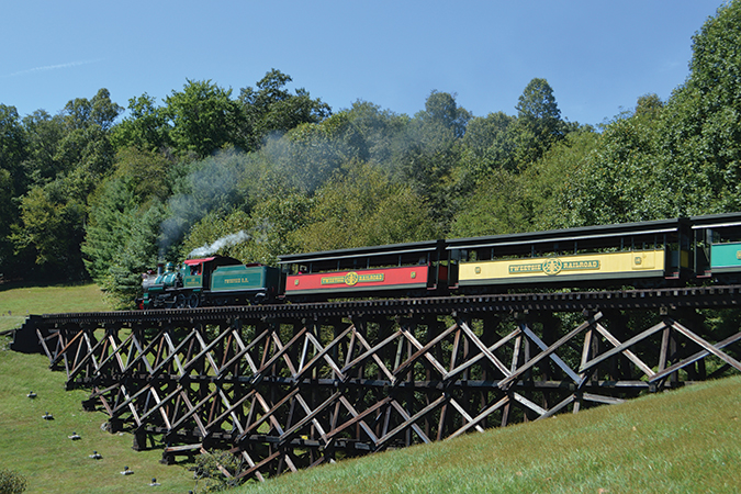 Roll on, Tweetsie: Engine No. 12 pulls passenger cars over a wooden trestle at Tweetsie Railroad in Blowing Rock, North Carolina.