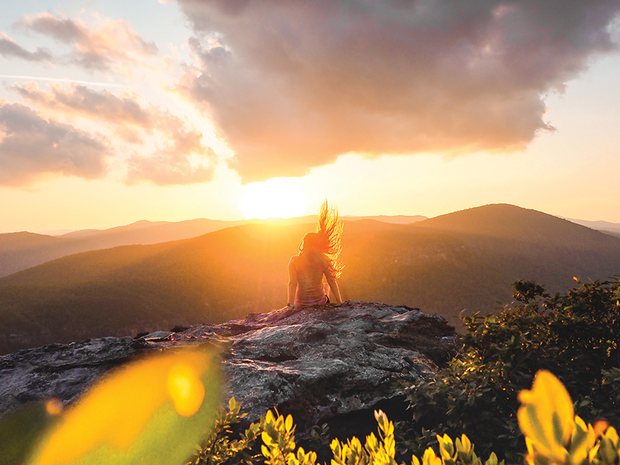 Kreiss' favorite shot so far, he says, was taken at Linville Gorge in North Carolina. The storybook-quality photo depicts an ethereal silhouette of a girl bathed in sun rays while perched on a massive rock at the top of the mountain. A pink-tinted cloud hovers overhead.