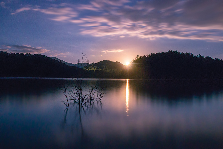 Western North Carolina’s Lake Santeetlah, surrounded by Nantahala National Forest lands, welcomes the rise of a full moon on a summer night.