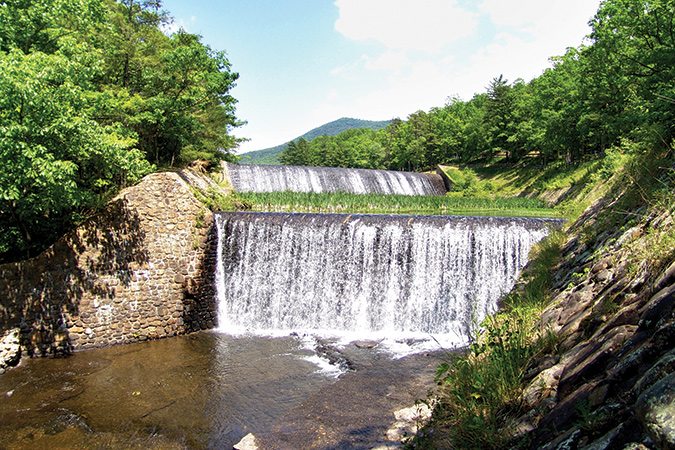 Douthat State Park, Virginia’s largest and among the initial six, is home to Douthat Lake, here spilling over its dam.