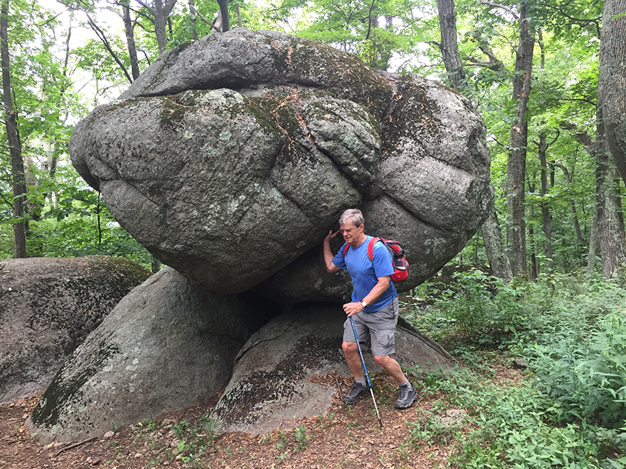 Kurt lowers a giant rock to its resting place along the Harkening Hill Trail.