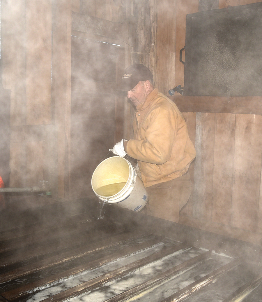 Sheets adds sugar maple sap to his 1930s’ vintage sheet metal flat pan.