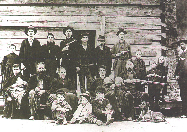 Devil Anse sits second from left with rifle pointed skyward.