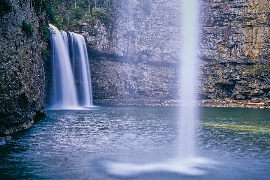 This view of Rockhouse Falls (foreground) framing Cane Creek Falls is in Fall Creek Falls State Park near Spencer, Tennessee. From the photographer: “Getting to this spot requires a steep descent on the locally infamous Cable Trail, so named for the cable to provide extra security. Water levels must be favorable; at dry times Rockhouse Falls disappears."