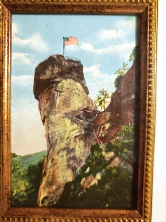 The postcard, carefully framed by Edwards, has been hung in the “mother room” at the Edwards cabin in Chimney Rock.