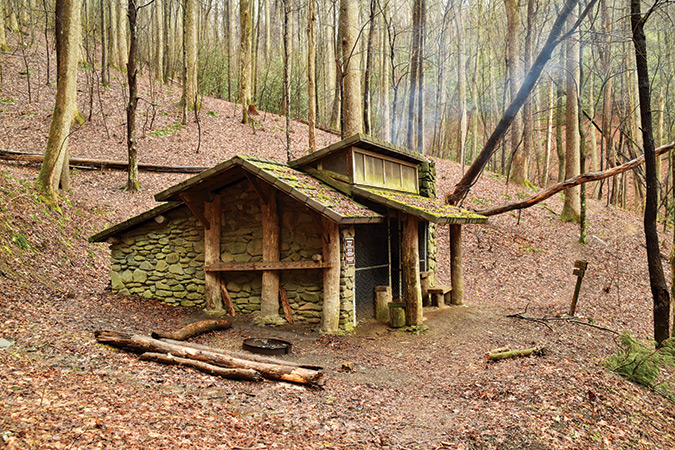 Davenport Gap Shelter (TN). Named for William Davenport, who surveyed the state line in 1821, this is the only shelter in the [Great Smokies] park that still has a bear cage installed in front. Nicknamed the “Smokies Sheraton,” it is a large stone and wooden shelter with a double sleeping platform, gable windows, wooden benches, a standing-height table, and a fireplace.
