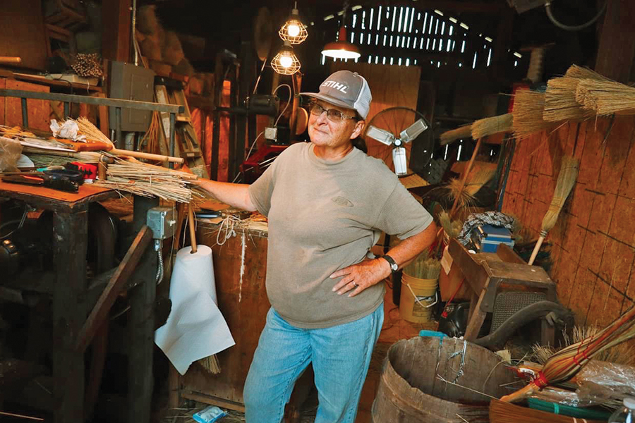 Wanda Hott shows off her newest broom press and demonstrates how she sews the brooms into shape.