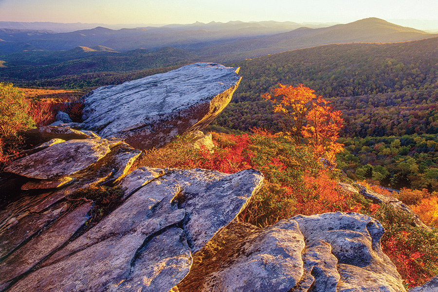A setting sun spotlights fall colors along Rough Ridge, a boulder-strewn summit near Blue Ridge Parkway Milepost 303. The 4,773-foot mountain top is less than a mile walk from the parkway.