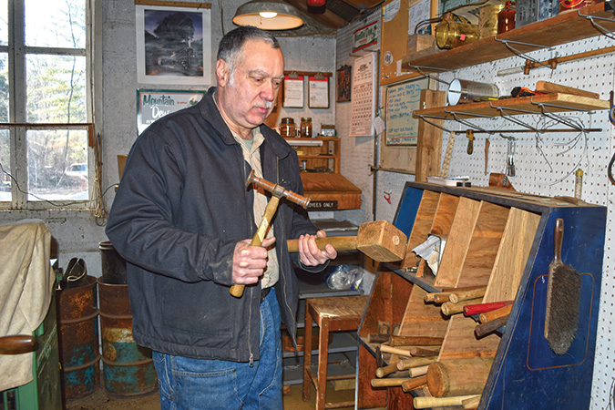 Kevin Riddle displays a sheet metal hammer, the design for which is from the 1800s, as is the design for the mallet that he made.