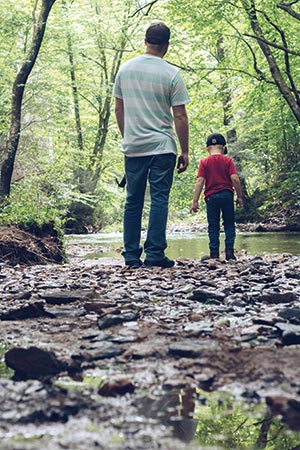 Kayden and Joe check out the river along the Round Meadow Overlook, looking for fish in the water.