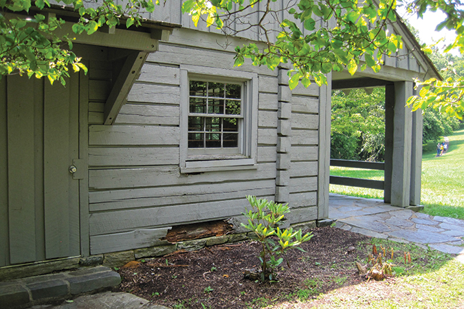 Wooden siding panels are rotting on the closed visitor center at Cumberland Knob. Signage has replaced people presence where parkway construction began in 1935.
