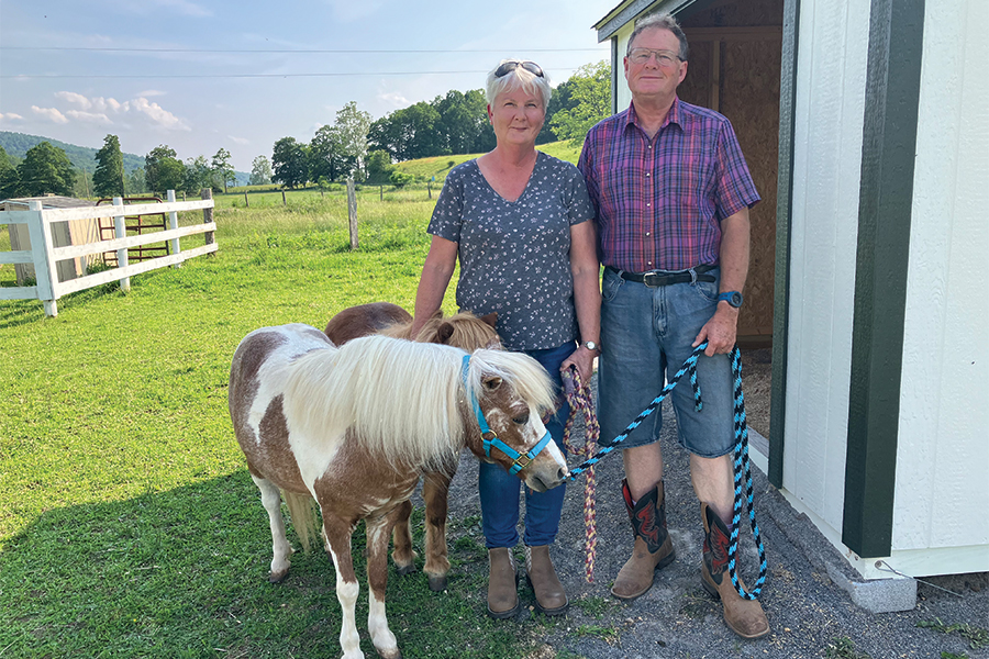 Drs. Koressa and Joe Malcolm accompany two minis to one of the nine run-in sheds.