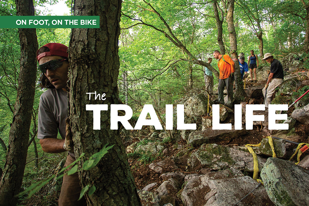 Thomas Jenkins (lovin’ on the tree) has been a part of building or protecting some 200 miles of trail.