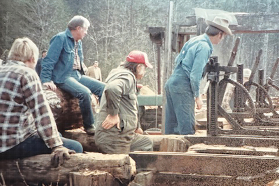 Bud Holloway (far right) works his sawmill behind The Pink Pig as President Jimmy Carter and others look on.