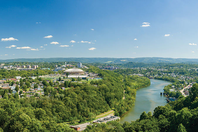 Panoramic view of Morgantown, West Virginia shows the Coliseum Arena and campus of West Virginia University as the Monongahela flows by.